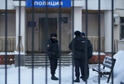 Police officers stand outside a police station where detained Russian opposition leader Alexei Navalny is being held, in Khimki outside Moscow, Russia, January 18, 2021.
