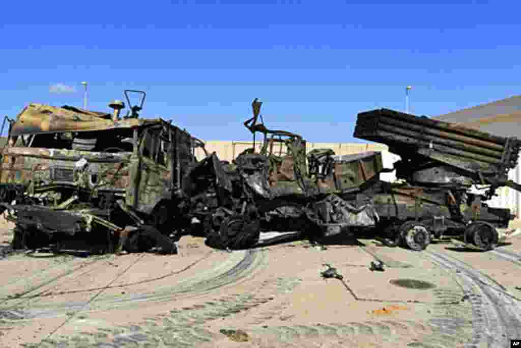 Destroyed military vehicles are seen at a naval military facility after last night's coalition air strikes in People's Port in eastern Tripoli, March 22, 2011