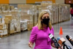 Phoenix Mayor Kate Gallego announces the arrival of more than one million pieces of PPE to help Phoenix schools reopen for the 2020-2021 school year as pallets fill a Phoenix Convention Center hall, Sept. 8, 2020, in Phoenix.