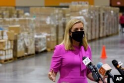 Phoenix Mayor Kate Gallego announces the arrival of more than one million pieces of PPE to help Phoenix schools reopen for the 2020-2021 school year as pallets fill a Phoenix Convention Center hall, Sept. 8, 2020, in Phoenix.
