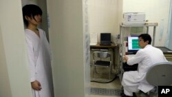 Satomi Kuroki, a 13-year-old junior high school student, receives a whole-body counter radiation check at Minimisoma City General Hospital just outside the 20-kilometer Fukushima Prefecture, Japan, March 7, 2012. 