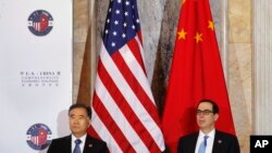 Chinese Vice Premier Wang Yang, left, and Treasury Secretary Steven Mnuchin, attend the U.S.-China Comprehensive Economic Dialogue at the Treasury Department in Washington, July 19, 2017.