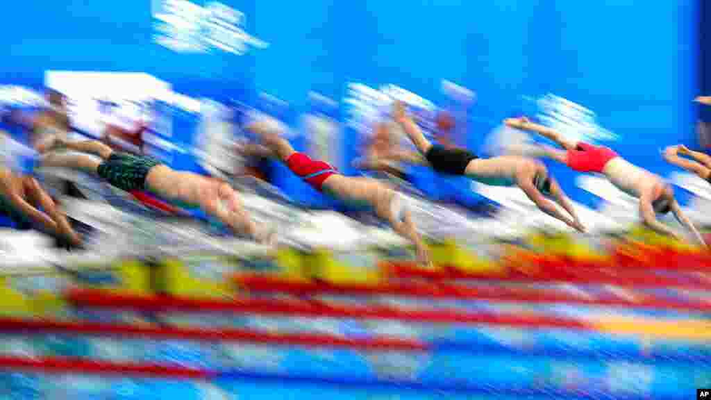 Swimmers jump in the pool at the beginning of the 400-meter relay men&#39;s final at the European Aquatics Championships in the Duna Arena in Budapest, Hungary.