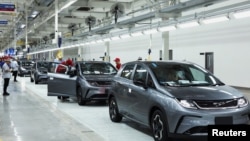 FILE - Workers check the EV cars inside BYD's first electric vehicle (EV) factory in Southeast Asia, a fast-growing regional EV market where it has become the dominant player, in Rayong, Thailand, July 4, 2024.