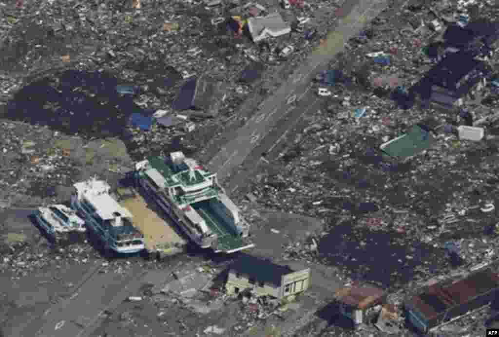 A ferry and other vessels get stuck at an intersection in Kesennuma, northern Japan, Monday, March 14, 2011, three days after a powerful earthquake-triggered tsunami hit the country's east coast. (AP Photo/The Yomiuri Shimbun, Atsushi Taketazu) JAPAN OUT,