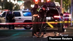 The body of a man who was shot dead lies on the ground in Portland