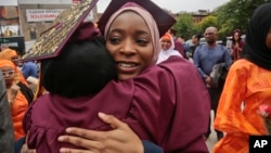 Brooklyn College humanities and social sciences graduate Ameera Badamasi, center, from Nigeria, hugs a student after the college's commencement ceremony, where Sen. Bernie Sanders, I-Vt., delivered the keynote address, May 30, 2017.