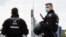FILE - Police officers wearing face masks are pictured during a rally against restrictions in place to limit the spread of the coronavirus, in Frankfurt, Germany, May 23, 2020.