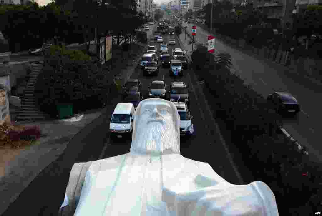 A statue of Lebanese Christian Maronite monk Saint Charbel, weighing 40 tons and measuring 23 meters, is transported on the Jounieh highway to the town of Faraya north east of Beirut.