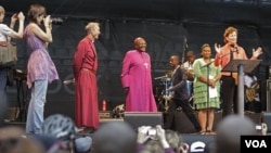 South African Archbishop Desmond Tutu, center, listens as former Irish President Mary Robinson speaks during a climate justice rally in Durban, South Africa, Sunday, Nov. 27, 2011. Amid fresh warnings of climate-related disasters in the future, delegates 