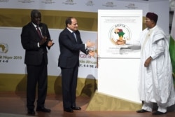 Left to right, Chairperson of the African Union Commission Moussa Faki Mahamat, Egyptian President and African Union Chairman Abdel Fattah al-Sissi (L) and Niger's President Mahamadou Issoufou are seen at the Palais des Congres in Niamey.