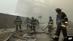 FILE — Firefighters work on the site of the World Trade Center after a terrorist attack on the twin towers in New York, Sept. 11, 2001. The remains of a man killed in the attack have been identified, the New York City medical examiner's office announced Thursday. 