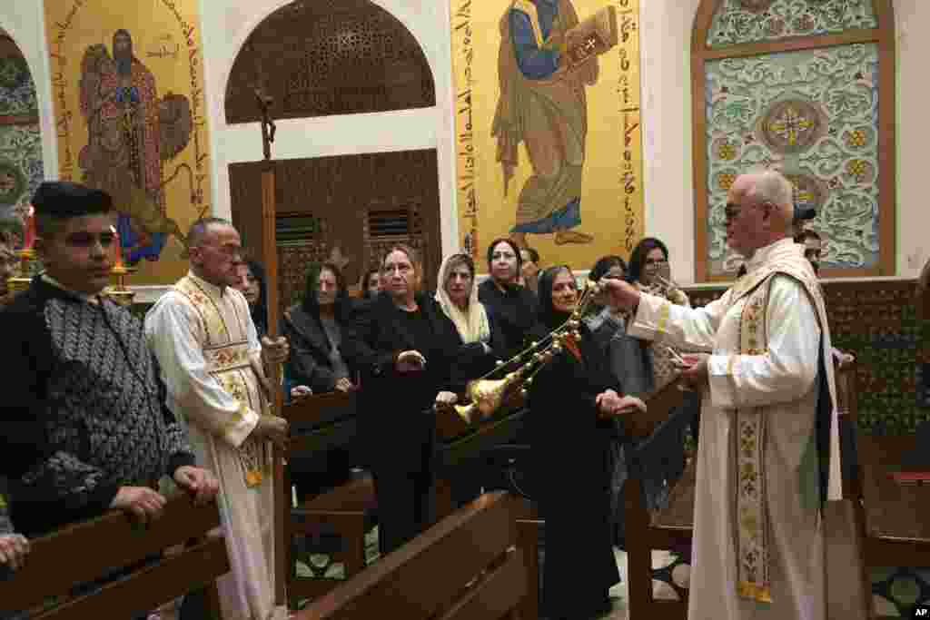 Iraqi Christians attend a Christmas Eve mass at the Sacred Heart Church of the Syriac Catholics in Basra, Iraq, Dec. 24, 2024. 