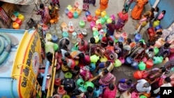 Indians stand in queues to fill vessels filled with drinking water from a water tanker in Chennai, capital of the southern Indian state of Tamil Nadu, June 19, 2019. 