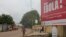 FILE - A billboard with an Ebola message looms over a street in Conakry, Guinea, Oct. 26, 2014.