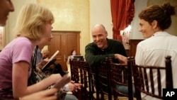 Humanist chaplain Bart Campolo, center, a former Evangelical Christian youth minister, and his wife, Marty, right, mingle with students before a forum at the University of Southern California in Los Angeles, Jan. 28, 2015.