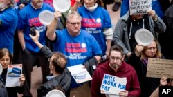 Furloughed government workers affected by the shutdown hold a silent protest against the ongoing partial government shutdown on Capitol Hill in Washington, Jan. 23, 2019. 