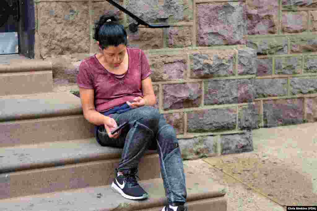 After injecting herself with heroin, a woman in a comatose state sits on the stairs of Prevention Point.