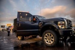 A truck's windows show damage from bullets after a gunfight in Culiacan, Mexico, Oct. 17, 2019, between security forces and the Sinaloa cartel.
