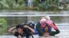 Residents evacuate as floodwaters submerged areas of Ye township in Mon State, Myanmar, Aug. 11, 2019.