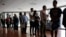 FILE - People stand in line to register for a job fair in Miami Lakes, Florida, July 19, 2016.