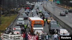 FILE - Pro-Palestinian demonstrators block traffic on the road that leads to John F Kennedy airport (JFK), amid the ongoing conflict between Israel and the Palestinian Islamist group Hamas, in New York City, U.S., December 27, 2023. 