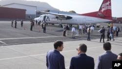 U.S. Secretary of State Marco Rubio, left, Panama's Minister of Public Security Frank Alexis Abrego, center, and Panama's Foreign Minister Javier Martinez-Acha, watch as people board a repatriation flight bound for Colombia, at Albrook Airport in Panama City, Feb. 3, 2025.