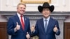 This handout picture taken and released by the Taiwan Presidential Office on May 27, 2024 shows Taiwan's President Lai Ching-te, right, posing with a hat received from U.S. Representative Michael McCaul, left, during a meeting at the Presidential Office in Taipei.