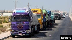 FILE - Trucks carrying aid line up near the Rafah border crossing between Egypt and the Gaza Strip, amid the ongoing conflict between Israel and Hamas, in Rafah, Egypt, Sept. 9, 2024.