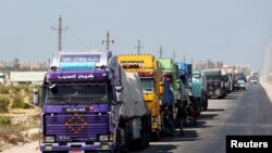 Trucks carrying aid line up near the Rafah border crossing between Egypt and the Gaza Strip, amid the ongoing conflict between Israel and Hamas, in Rafah, Egypt, Sept. 9, 2024.