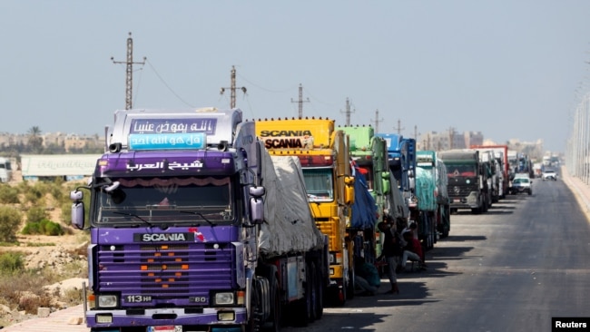 Trucks carrying aid line up near the Rafah border crossing between Egypt and the Gaza Strip, amid the ongoing conflict between Israel and Hamas, in Rafah, Egypt, Sept. 9, 2024.