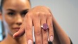 FILE - Model Paula Nissen wears a 10.57-carat purplish-pink diamond called Eternal Pink in New York City on Tuesday, March 28, 2023. Sotheby's auction house estimates the diamond will sell for over $35 million in June. 