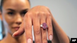 FILE: Model Paula Nissen wears a 10.57-carat purplish-pink diamond called Eternal Pink in New York City on Tuesday, March 28, 2023. Sotheby's auction house estimates the diamond will sell for over $35 million in June. 