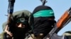 FILE PHOTO: Palestinian fighters from the armed wing of Hamas take part in a military parade.