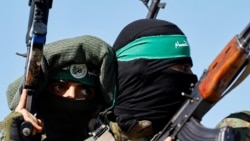 FILE PHOTO: Palestinian fighters from the armed wing of Hamas take part in a military parade.