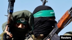 FILE PHOTO: Palestinian fighters from the armed wing of Hamas take part in a military parade.