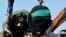FILE PHOTO: Palestinian fighters from the armed wing of Hamas take part in a military parade.