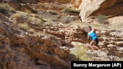 Professional trail runner Tim Freriks running to break the single crossing record. (Sunny Margerum/HOKA One One via AP)