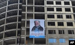 An electoral poster of current Afghan chief executive and presidential candidate Abdullah Abdullah is seen on a building under construction during the first day of campaigning in Kabul, Afghanistan, July 28, 2019.
