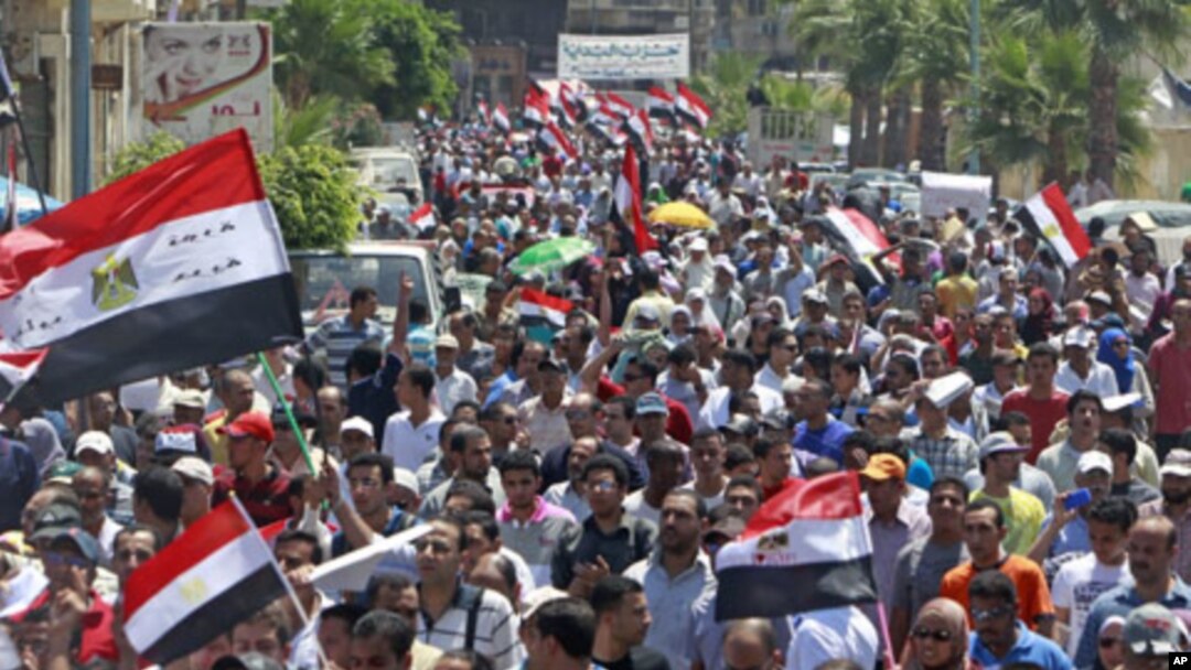 Egyptians chant slogans against the government and military rulers after Friday prayers, 230 kilometers north of Cairo, in Alexandria, Egypt, July 15, 2011