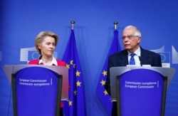 FILE - European Commission President Ursula von der Leyen and EU High Representative for Foreign Affairs and Security Policy Josep Borrell hold a joint news conference, in Brussels, Belgium, Jan. 8, 2020.