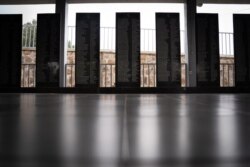 FILE - Names of victims of one of many Rwanda genocide massacres are seen on panels at the Bisesero Genocide Memorial in Bisesero, western Rwanda, Dec. 2, 2020.