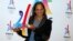 French track and field sprinter Christine Arron holds the logo as she attends the presentation of the Paris candidacy for the 2024 Olympic and Paralympic Games in Paris, Feb. 17, 2016.