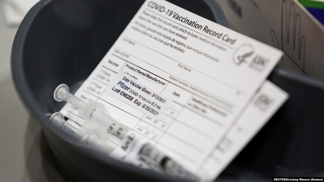 USA, Seatle, Washington, A Pfizer coronavirus disease (COVID-19) vaccine card is seen at a mass vaccination site