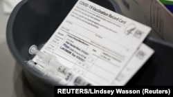 USA, Seatle, Washington, A Pfizer coronavirus disease (COVID-19) vaccine card is seen at a mass vaccination site