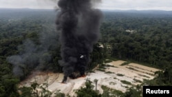 FILE - Machines are destroyed at an illegal gold mine during an operation conducted by agents of the Brazilian Institute for the Environment and Renewable Natural Resources, in national parks near Novo Progresso, Brazil, Nov. 5, 2018. 