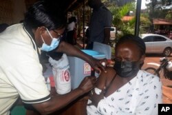 FILE—A Ugandan woman receives a dose of yellow fever vaccine at Kiswa Health Center III in Kampala, Uganda, April 2, 2024.