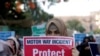 FILE - A supporter of religious and political party Jamaat-e-Islami carries a sign decrying a gang rape that occurred along a highway and condemning violence against women and girls, during a demonstration in Karachi, Pakistan, Sept. 11, 2020.