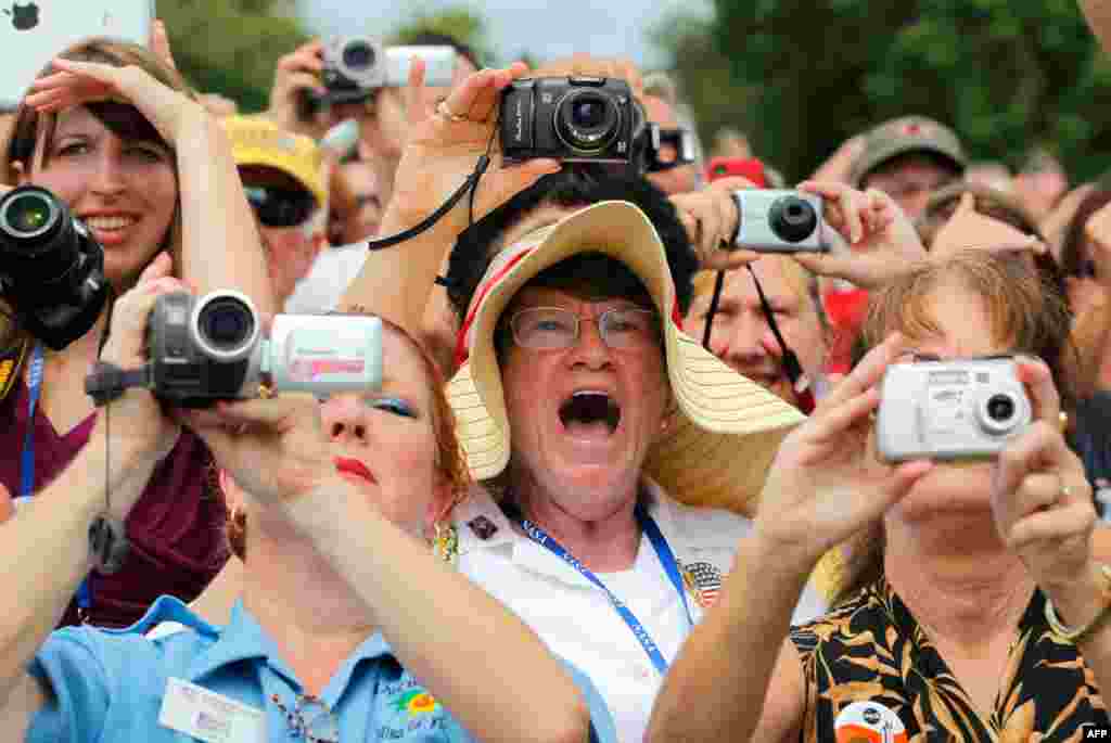 Spectators watch space shuttle Atlantis STS-135 lift off at the Kennedy Space Center in Cape Canaveral, Florida, July 8, 2011. The 12-day mission to the International Space Station was the last mission in the Space Shuttle program. (Reuters)