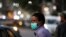 A man wearing a protective mask walks outside a shopping area, as the outbreak of coronavirus disease (COVID-19) continues, in Karachi, Pakistan December 29, 2020. REUTERS/Akhtar Soomro/File Photo